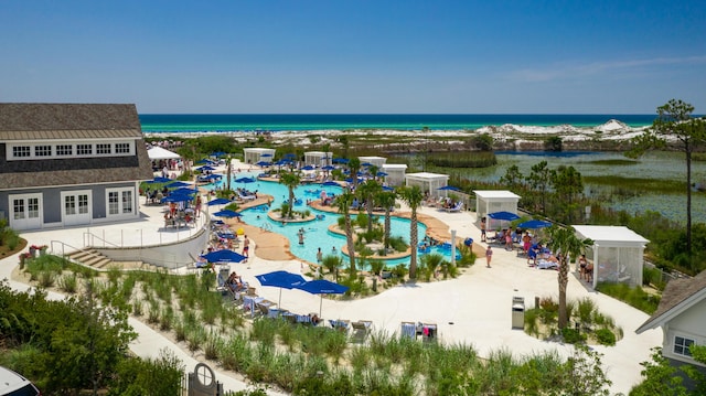 birds eye view of property with a beach view and a water view