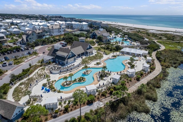 birds eye view of property with a beach view and a water view
