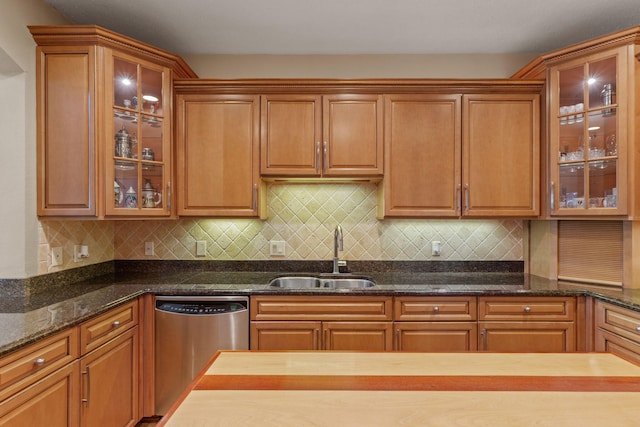 1124 Willowood Cir, Gulf Breeze, FL 32563 - kitchen featuring stainless steel dishwasher, glass insert cabinets, a sink, and backsplash