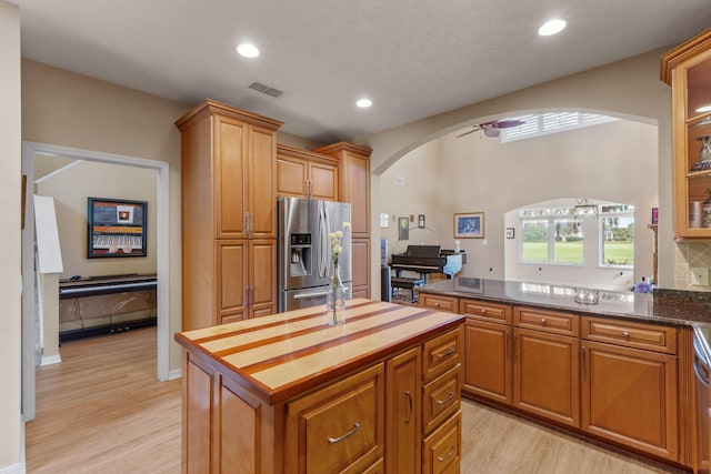 1124 Willowood Cir, Gulf Breeze, FL 32563 - kitchen with visible vents, arched walkways, stainless steel fridge, light wood-style floors, and recessed lighting