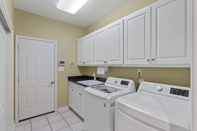 1124 Willowood Cir, Gulf Breeze, FL 32563 - laundry room featuring light tile patterned floors, separate washer and dryer, a sink, baseboards, and cabinet space