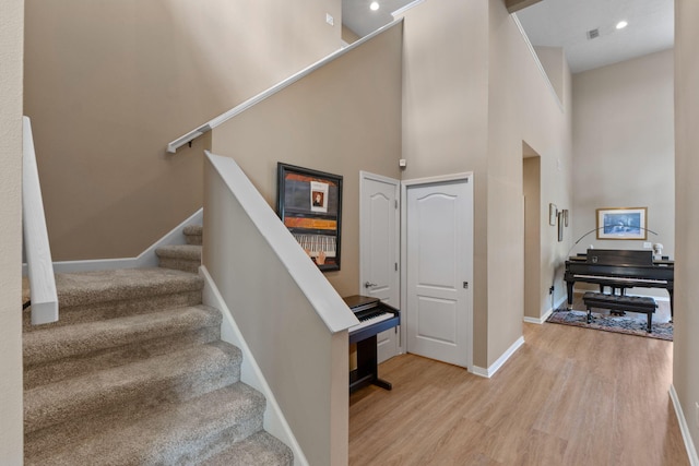 1124 Willowood Cir, Gulf Breeze, FL 32563 - stairs with visible vents, baseboards, recessed lighting, a towering ceiling, and wood finished floors