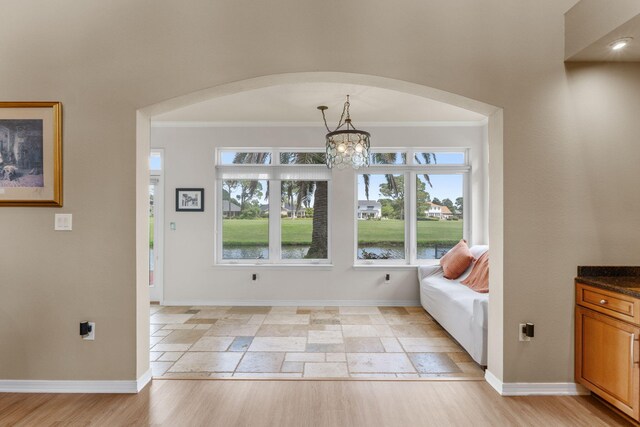 1124 Willowood Cir, Gulf Breeze, FL 32563 - entrance foyer featuring a chandelier, arched walkways, crown molding, and baseboards
