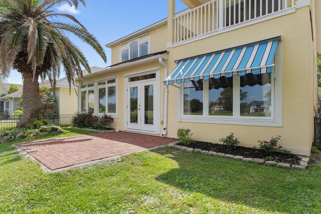 1124 Willowood Cir, Gulf Breeze, FL 32563 - rear view of house with french doors, fence, a patio, and stucco siding