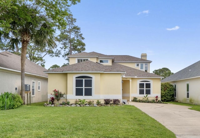 1124 Willowood Cir, Gulf Breeze, FL 32563 - view of front of house featuring concrete driveway, a front yard, and stucco siding