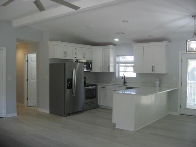 13 Plantation Way, Santa Rosa Beach, FL 32459 - kitchen featuring white cabinets, a sink, light countertops, appliances with stainless steel finishes, and a peninsula