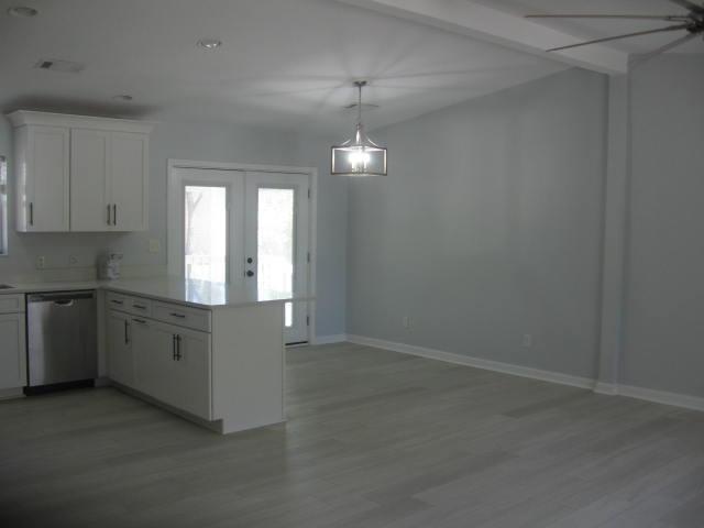 13 Plantation Way, Santa Rosa Beach, FL 32459 - kitchen with a peninsula, french doors, light countertops, white cabinets, and dishwasher
