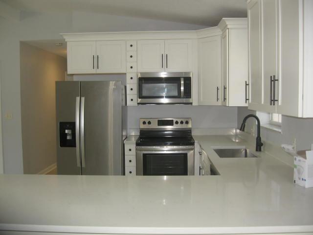 13 Plantation Way, Santa Rosa Beach, FL 32459 - kitchen featuring a sink, light countertops, appliances with stainless steel finishes, white cabinetry, and lofted ceiling