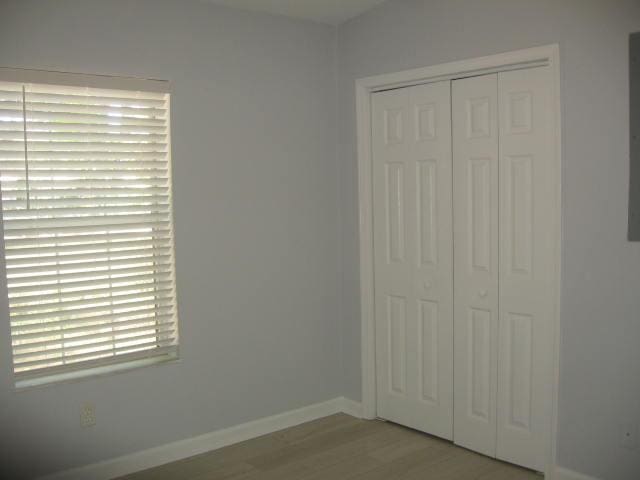 13 Plantation Way, Santa Rosa Beach, FL 32459 - unfurnished bedroom with a closet, baseboards, and wood finished floors