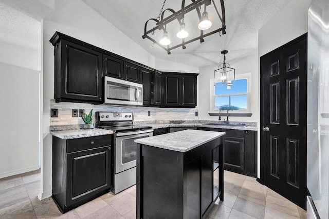133 Wild Horse Dr, Crestview, FL 32536 - kitchen with appliances with stainless steel finishes, dark cabinets, a chandelier, a sink, and a textured ceiling