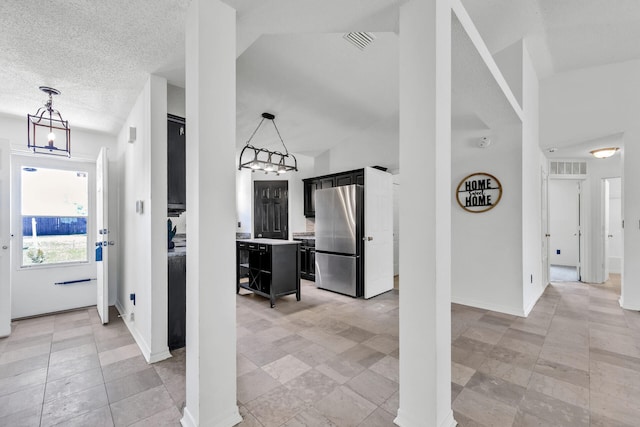 133 Wild Horse Dr, Crestview, FL 32536 - hallway featuring a chandelier, baseboards, vaulted ceiling, and a textured ceiling