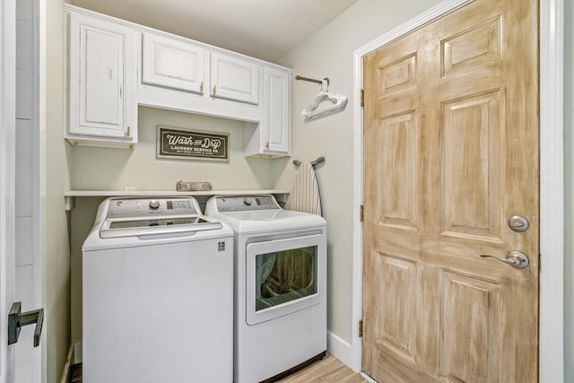 52 Secret Harbor Dr, Miramar Beach, FL 32550 - laundry area featuring washer and clothes dryer, cabinet space, and light wood-style floors