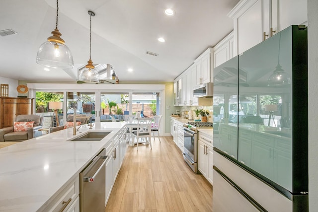 52 Secret Harbor Dr, Miramar Beach, FL 32550 - kitchen featuring appliances with stainless steel finishes, a sink, white cabinetry, plenty of natural light, and vaulted ceiling