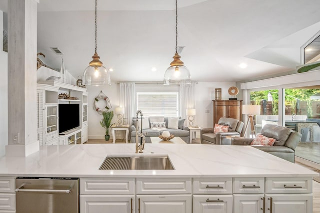 52 Secret Harbor Dr, Miramar Beach, FL 32550 - kitchen featuring a sink, open floor plan, stainless steel dishwasher, white cabinetry, and light stone countertops