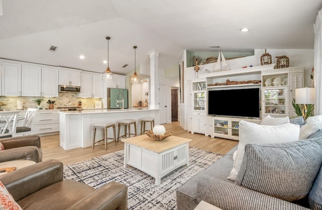 52 Secret Harbor Dr, Miramar Beach, FL 32550 - living room with vaulted ceiling, light wood-type flooring, and recessed lighting