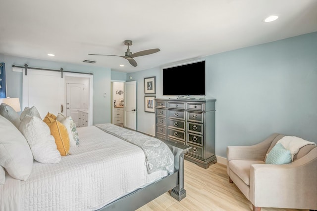 52 Secret Harbor Dr, Miramar Beach, FL 32550 - bedroom with light wood-type flooring, recessed lighting, a barn door, ceiling fan, and baseboards