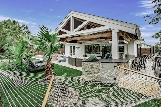 52 Secret Harbor Dr, Miramar Beach, FL 32550 - rear view of house with an outdoor living space, a fenced backyard, and a patio area