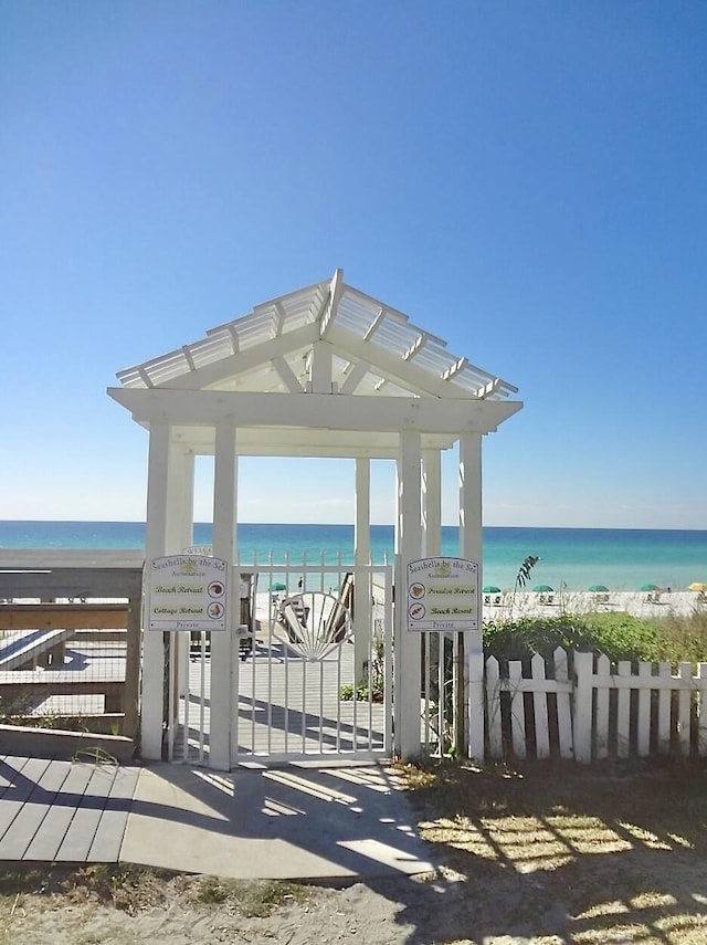 52 Secret Harbor Dr, Miramar Beach, FL 32550 - view of home's community featuring a water view, a carport, and a gate