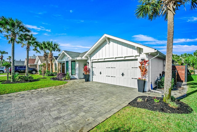 52 Secret Harbor Dr, Miramar Beach, FL 32550 - single story home with board and batten siding, a garage, a front lawn, and decorative driveway