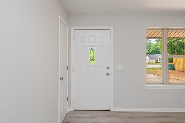 interior space with light wood-type flooring and baseboards