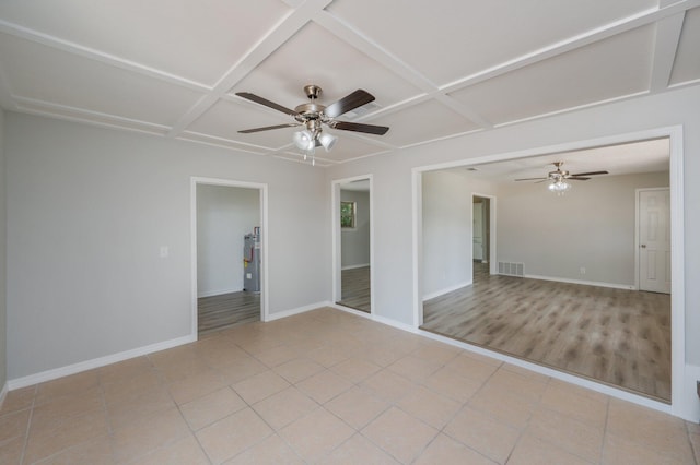 empty room featuring ceiling fan, visible vents, baseboards, and coffered ceiling