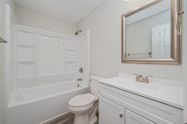 bathroom with vanity, washtub / shower combination, and toilet