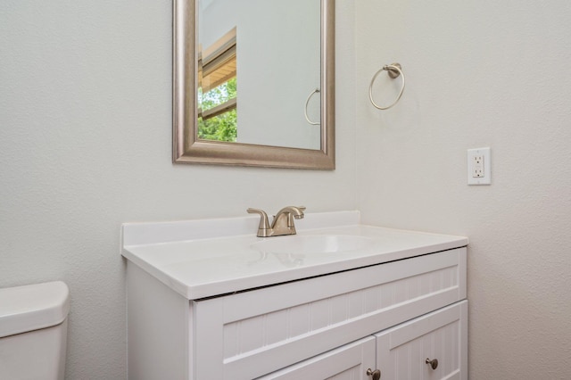 bathroom featuring vanity and toilet