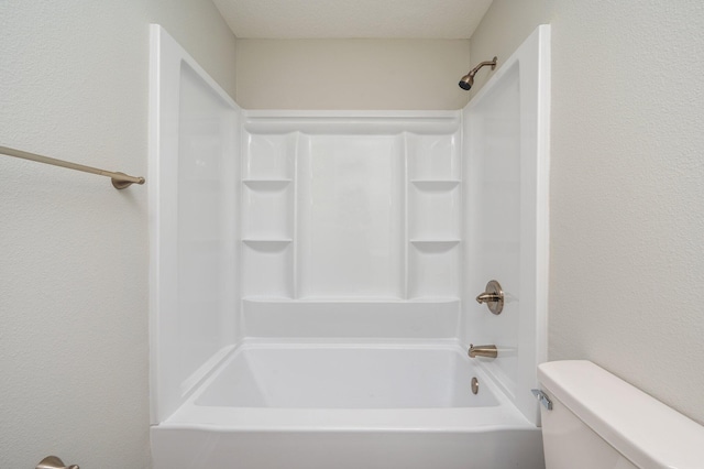 bathroom with bathtub / shower combination and toilet