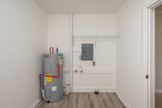 utility room featuring electric panel and electric water heater
