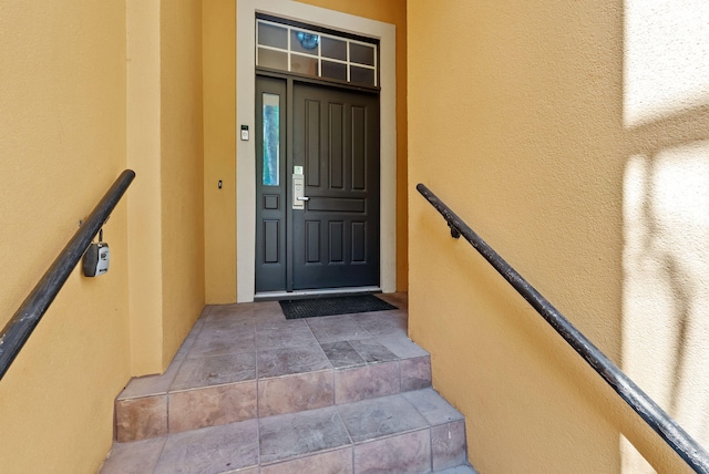 property entrance featuring stucco siding