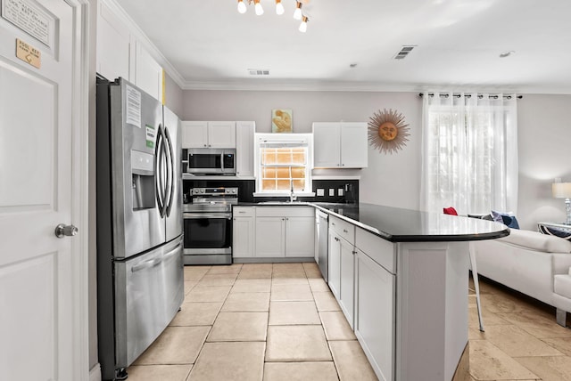 kitchen featuring a kitchen bar, visible vents, dark countertops, stainless steel appliances, and open floor plan