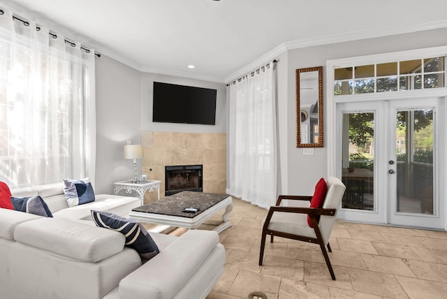 living room featuring stone tile floors, recessed lighting, ornamental molding, and a tile fireplace