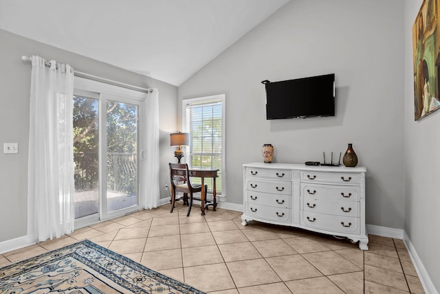 sitting room featuring baseboards, vaulted ceiling, and light tile patterned flooring