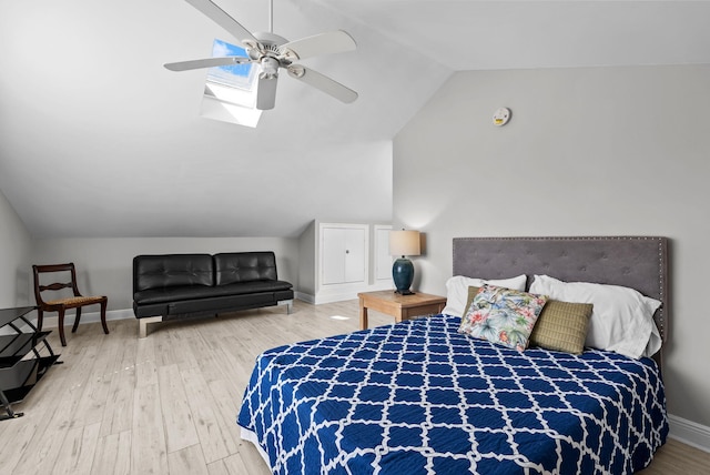 bedroom featuring baseboards, wood finished floors, a ceiling fan, and lofted ceiling
