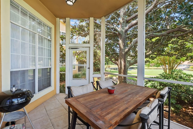 sunroom featuring outdoor dining area