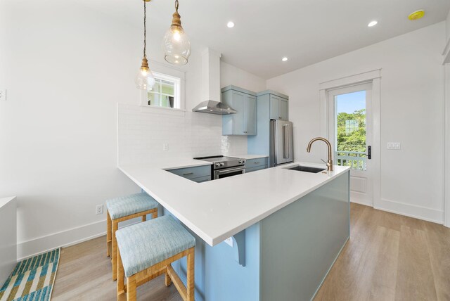 272 Beach Bike Way, Seacrest, FL 32461 - kitchen with wall chimney exhaust hood, stainless steel appliances, light wood-style floors, a sink, and recessed lighting