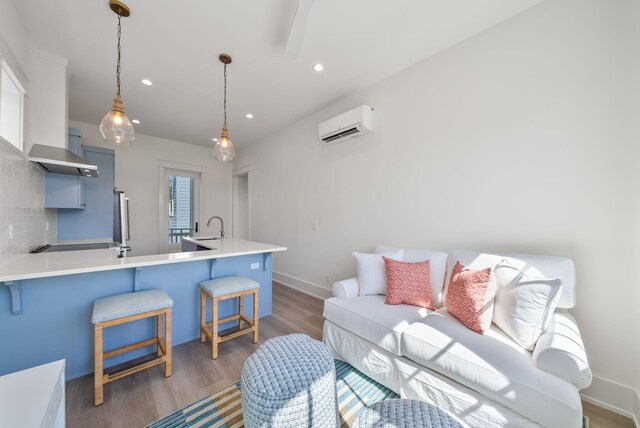 272 Beach Bike Way, Seacrest, FL 32461 - living area featuring a wall mounted air conditioner, light wood-type flooring, recessed lighting, and baseboards