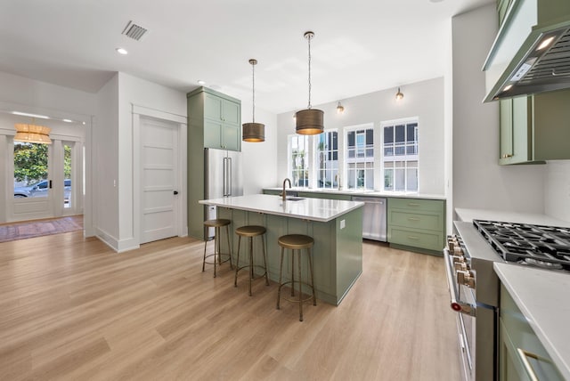 272 Beach Bike Way, Seacrest, FL 32461 - kitchen featuring green cabinets, premium range hood, premium appliances, a breakfast bar area, and light wood-style floors