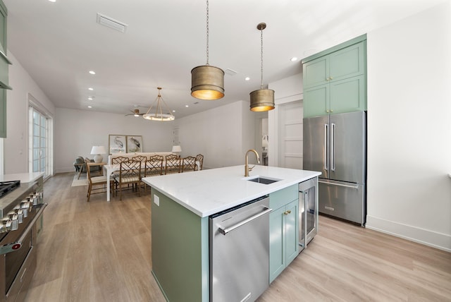 272 Beach Bike Way, Seacrest, FL 32461 - kitchen featuring high quality appliances, green cabinetry, light wood-style flooring, and recessed lighting