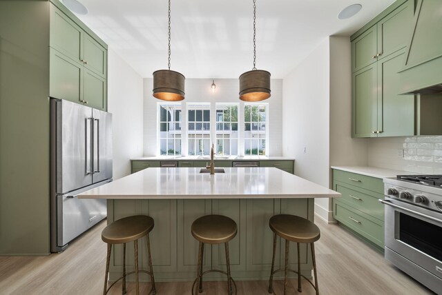 272 Beach Bike Way, Seacrest, FL 32461 - kitchen with green cabinets, appliances with stainless steel finishes, light wood-style floors, and light countertops