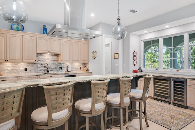 21 S Anchors Lake Dr, Santa Rosa Beach, FL 32459 - kitchen featuring visible vents, beverage cooler, island exhaust hood, and a kitchen bar