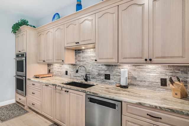 21 S Anchors Lake Dr, Santa Rosa Beach, FL 32459 - kitchen with tasteful backsplash, light stone countertops, a sink, and appliances with stainless steel finishes