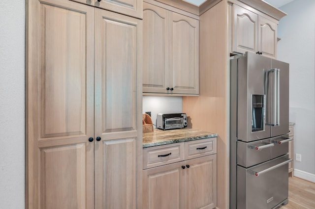 21 S Anchors Lake Dr, Santa Rosa Beach, FL 32459 - kitchen with baseboards, light brown cabinets, high quality fridge, light wood finished floors, and light stone countertops