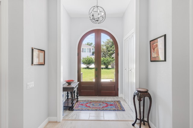 21 S Anchors Lake Dr, Santa Rosa Beach, FL 32459 - entrance foyer featuring arched walkways, a notable chandelier, french doors, and baseboards