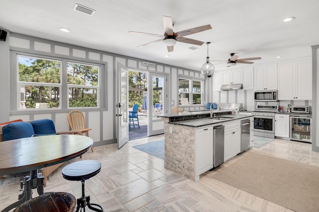 21 S Anchors Lake Dr, Santa Rosa Beach, FL 32459 - kitchen with wine cooler, ceiling fan, plenty of natural light, and stainless steel appliances