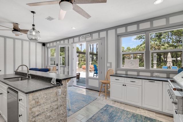 21 S Anchors Lake Dr, Santa Rosa Beach, FL 32459 - kitchen with white cabinets, french doors, a sink, and visible vents