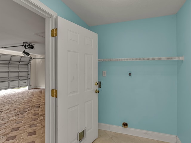 27 Hidden Harbor Ln, Miramar Beach, FL 32550 - laundry area featuring hookup for an electric dryer, baseboards, and tile patterned floors