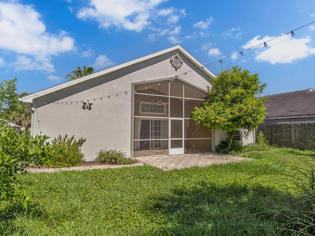 27 Hidden Harbor Ln, Miramar Beach, FL 32550 - back of house featuring stucco siding, a patio, and a sunroom
