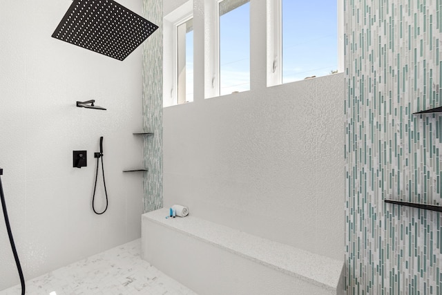 bathroom with tiled shower