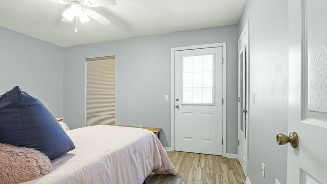 bedroom featuring light wood finished floors and baseboards